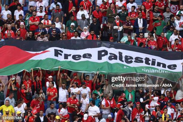 Fans hold a Flag of Palestine with Free Palestine written on it during the FIFA World Cup Qatar 2022 Group D match between Tunisia and Australia at...