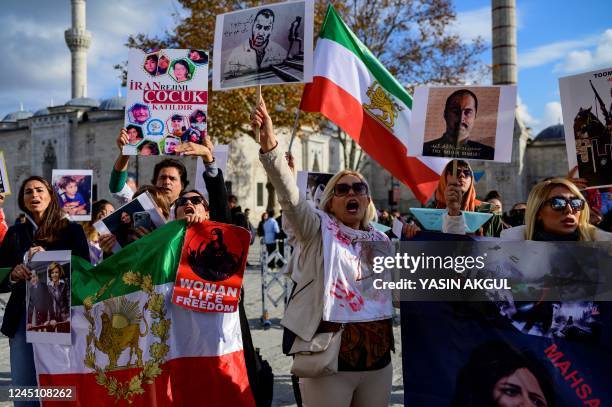 People hold placards bearing portraits of Iranian dissident Hossein Ronaghi and Iranian rapper Toomaj Salehi , who are arrested in Iran, as they take...