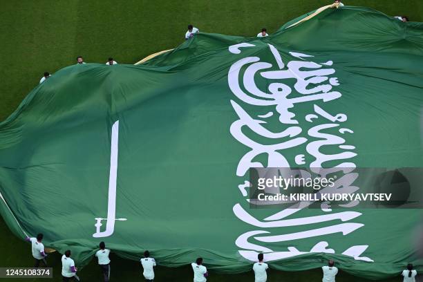 The flag of Saudi Arabia is displayed during the presentation ahead of the Qatar 2022 World Cup Group C football match between Poland and Saudi...