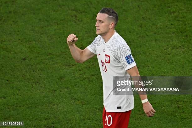 Poland's midfielder Piotr Zielinski celebrates after scoring his team's first goal during the Qatar 2022 World Cup Group C football match between...