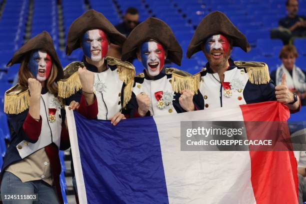 France fans pose for a picture with the French flag inside the stadium ahead of kick off in the Qatar 2022 World Cup Group D football match between...