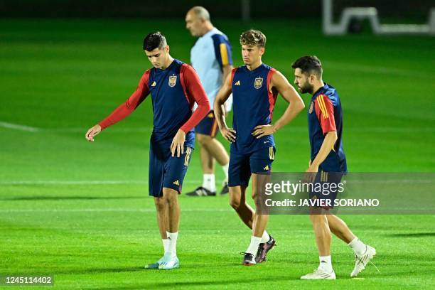Spain's forward Alvaro Morata, midfielder Marcos Llorente and defender Jordi Alba take part in a training session at the Qatar University in Doha on...