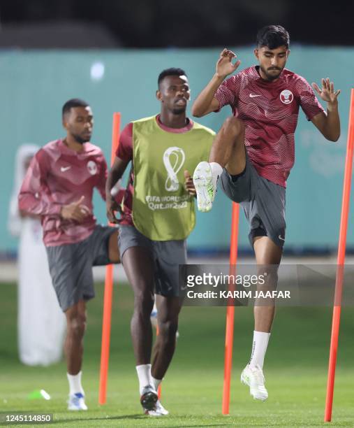 Qatar's midfielder Hatim Abdelaziz , Qatar's forward Mohammed Muntari and Qatar's midfielders Naif Abdulraheem take part in training session at the...