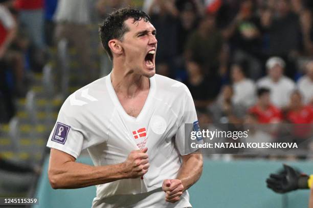 Denmark's defender Andreas Christensen celebrates scoring his team's first goal during the Qatar 2022 World Cup Group D football match between France...