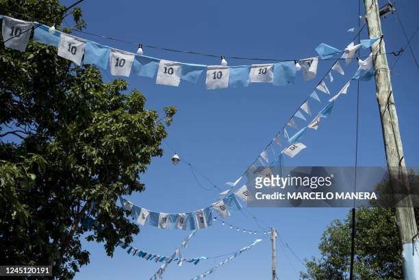 View of a street decorated with the colors of Argentina and Lionel Messi's number 10 in the football star's childhood neighborhood in Rosario,...