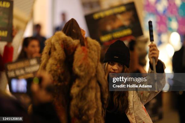 Anti-fur activists demonstrate outside the Louis Vuitton store on New Bond Street on November 26, 2022 in London, England. UK retailers are bracing...