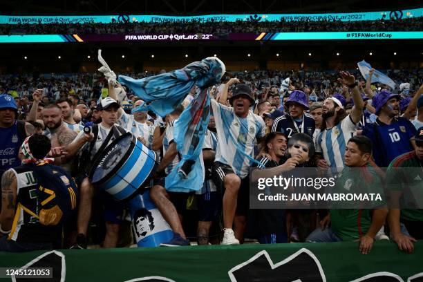 Argentina supporters cheer ahead of the Qatar 2022 World Cup Group C football match between Argentina and Mexico at the Lusail Stadium in Lusail,...