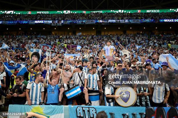 Argentina supporters cheer ahead of the Qatar 2022 World Cup Group C football match between Argentina and Mexico at the Lusail Stadium in Lusail,...
