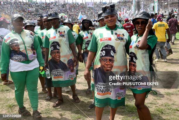 Supporters wear outfits depicting a campaign poster showing presidential candidate of All Progressives Congress Bola Tinubu and runningmate Abdullahi...