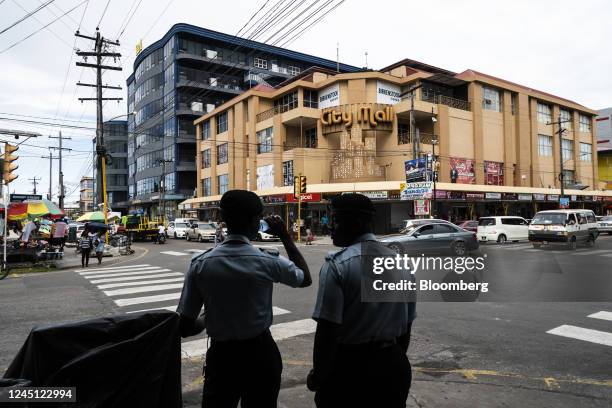 Police officers stand guard on a street in Georgetown, Guyana, on Monday, Nov. 21, 2022. Since the first oil was drilled three years ago, Guyana's...