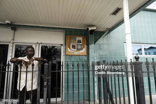 Pedestrian stands outside the Bank of Guyana headquarters in Georgetown, Guyana, on Monday, Nov. 21, 2022. Since the first oil was drilled three...