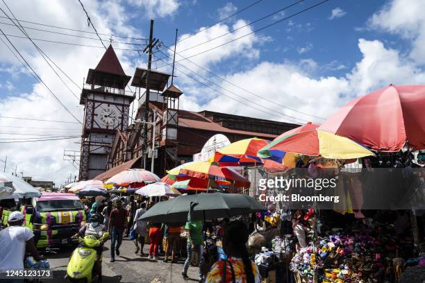 Pedestrians walk past street vendors at the Stabroek Market in Georgetown, Guyana, on Monday, Nov. 21, 2022. Since the first oil was drilled three...