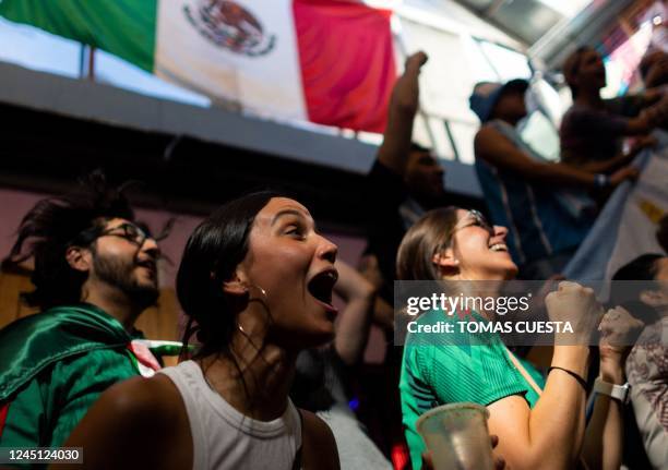 Fans of Mexico and Argentina watch the live broadcast of the Qatar 2022 World Cup group C football match between Argentina and Mexico, at La Fabrica...
