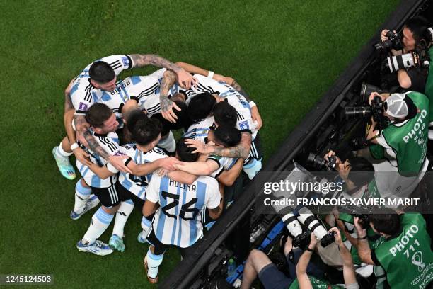 Argentina's forward Lionel Messi celebrates scoring the opening goal with his teammates during the Qatar 2022 World Cup Group C football match...