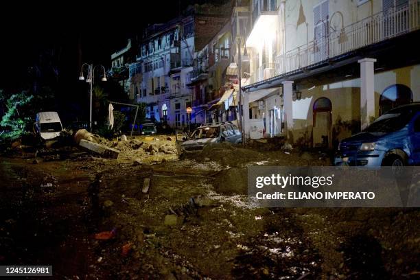 Photograph shows a muddy street following heavy rains that caused a landslide in Casamicciola on Ischia island on November 26, 2022. - One woman died...