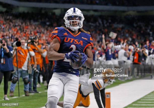 Wide receiver Joshua Cephus of the UTSA Roadrunners catches a touchdown pass ahead of Kobe Hylton of the UTEP Miners in the first half at Alamodome...