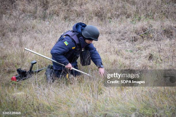 Ukrainian sapper clears mines at the site of recent fighting between the Russian and Ukrainian armies on the outskirts of Kherson.