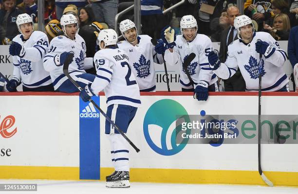 Pontus Holmberg of the Toronto Maple Leafs celebrates with teammates on the bench after scoring a goal in the second period during the game against...