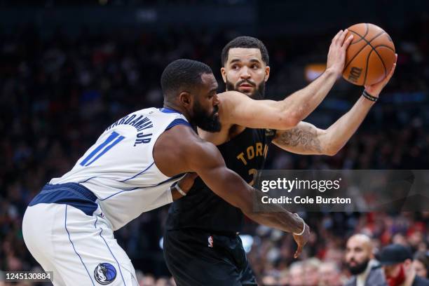 Fred VanVleet of the Toronto Raptors keeps the ball away from Tim Hardaway Jr. #11 of the Dallas Mavericks during the second half of their NBA game...