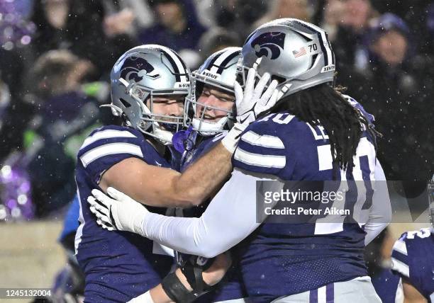 Tight end Sammy Wheeler of the Kansas State Wildcats celebrates with teammates after a touchdown against the Kansas Jayhawks during the first half at...