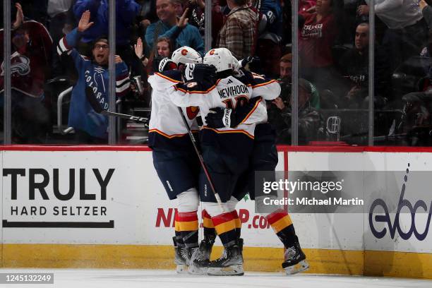 Martin Kaut, Alex Newhook and Dryden Hunt of the Colorado Avalanche celebrate a goal against the Dallas Stars at Ball Arena on November 26, 2022 in...