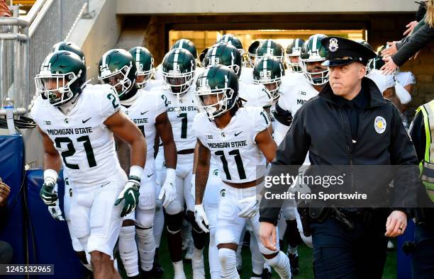 Michigan State cornerback Dillon Tatum and wide receiver Tyrell Henry run out the tunnel with teammates and a police escort during the Michigan State...