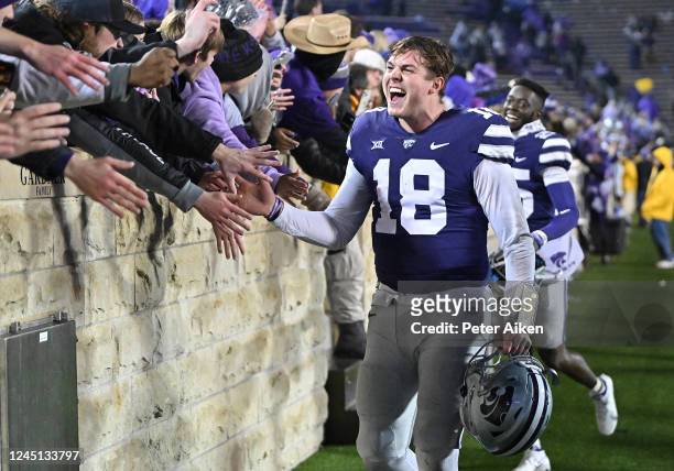 Quarterback Will Howard of the Kansas State Wildcats celebrates with K-State fans after beating the Kansas Jayhawks at Bill Snyder Family Football...