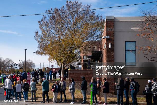 People are seen in line to vote on the first day of early voting in Cobb County on Saturday, November 26, 2022 in Marietta, GA.