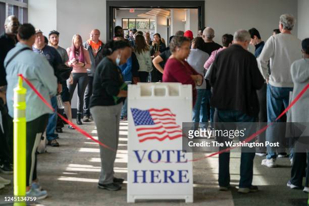 People are seen in line to vote on the first day of early voting in Cobb County on Saturday, November 26, 2022 in Marietta, GA.