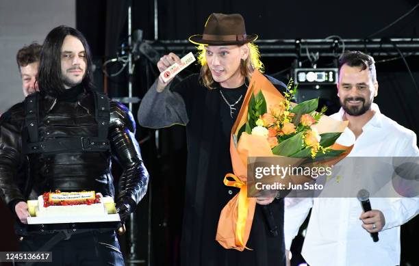 Jamie Campbell Bower receives their birthday cake and bouquet during the closing ceremony of Tokyo Comic Con 2022 at Makuhari Messe on November 27,...