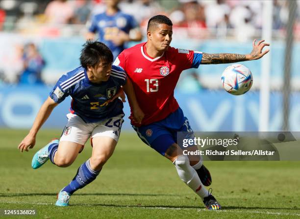 Yuki Soma of Japan and Gerson Torres of Costa Rica challenge during the FIFA World Cup Qatar 2022 Group E match between Japan and Costa Rica at Ahmad...