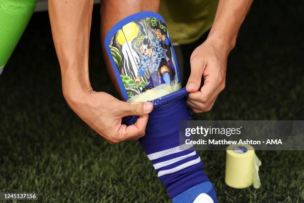 Gaku Shibasaki of Japan pulls his socks over his shin pads which have an Anime Samurai image on during the FIFA World Cup Qatar 2022 Group E match...