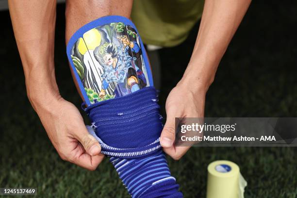 Gaku Shibasaki of Japan pulls his socks over his shin pads which have an Anime Samurai image on during the FIFA World Cup Qatar 2022 Group E match...