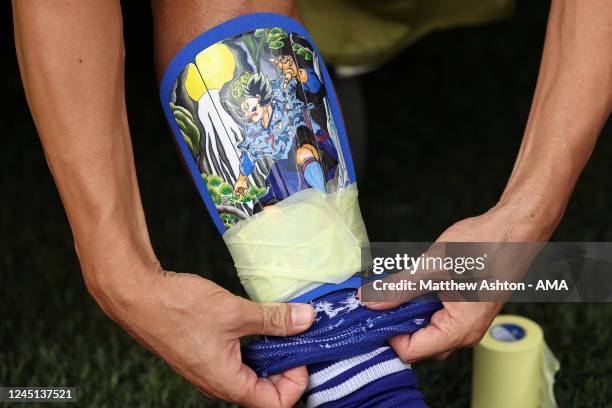 Gaku Shibasaki of Japan puts on his shin pads which feature a Anime Samurai image before the FIFA World Cup Qatar 2022 Group E match between Japan...