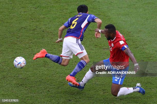 Japan's midfielder Wataru Endo and Costa Rica's defender Kendall Waston fight for the ball during the Qatar 2022 World Cup Group E football match...