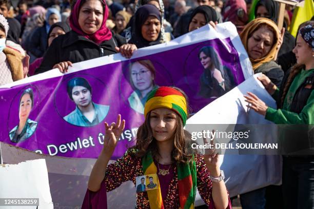 Young Syrian-Kurdish girl joins demonstrators protesting against Turkey's threats against their region, in the northeastern Syrian Kurdish-majority...