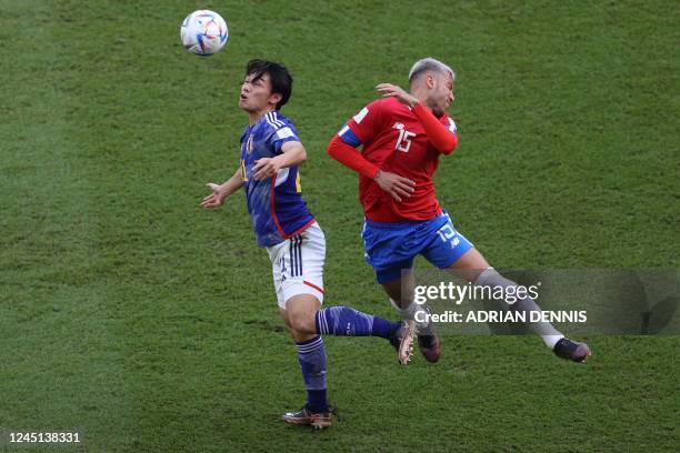 Japan's forward Ayase Ueda and Costa Rica's defender Francisco Calvo fight for the ball during the Qatar 2022 World Cup Group E football match...