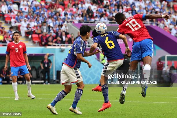 Costa Rica's defender Kendall Waston heads the ball past Japan's midfielder Wataru Endo during the Qatar 2022 World Cup Group E football match...