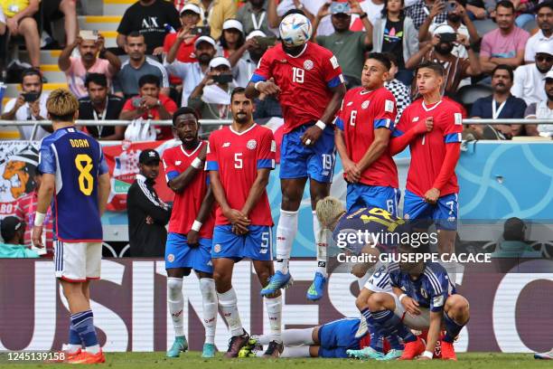 Costa Rica's defender Kendall Waston jumps to block a free-kick during the Qatar 2022 World Cup Group E football match between Japan and Costa Rica...