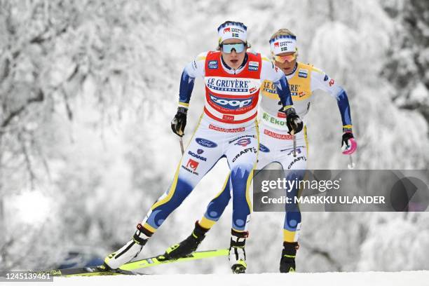 Sweden's Ebba Andersson and Frida Karlsson compete during the cross-country 20km pursuit freestyle competition of the Women's FIS Ski Cross-Country...