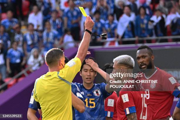 Costa Rica's defender Francisco Calvo receives a yellow card during the Qatar 2022 World Cup Group E football match between Japan and Costa Rica at...