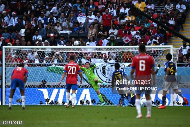 Japan's goalkeeper Shuichi Gonda concedes the first goal scored by Costa Rica's defender Keysher Fuller during the Qatar 2022 World Cup Group E...