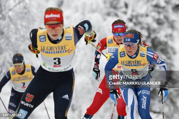 Germanz's Katharina Hennig and Finland's Krista Pärmäkoski compete during the cross-country 20km pursuit freestyle competition of the Women's FIS Ski...