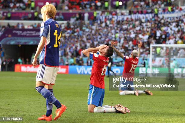 Bryan Oviedo and Francisco Calvo of Costa Rica on their knees celebrating victory during the FIFA World Cup Qatar 2022 Group E match between Japan...