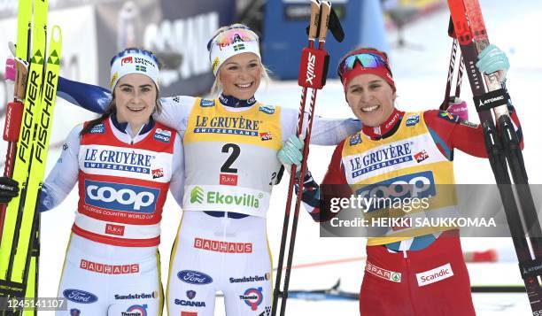 Second placed Sweden's Ebba Andersson, winner Sweden's Frida Karlsson, and third placed Norway's Tiril Udnes Weng celebrate after the cross-country...