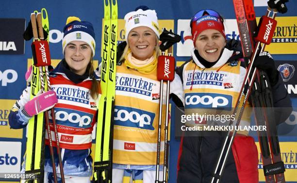 Second placed Sweden's Ebba Andersson, winner Sweden's Frida Karlsson, and third placed Norway's Tiril Udnes Weng celebrate on the podium after the...