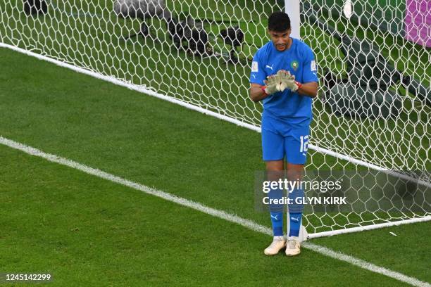 Morocco's goalkeeper Monir El Kajoui gives instructions to his teammates during the Qatar 2022 World Cup Group F football match between Belgium and...