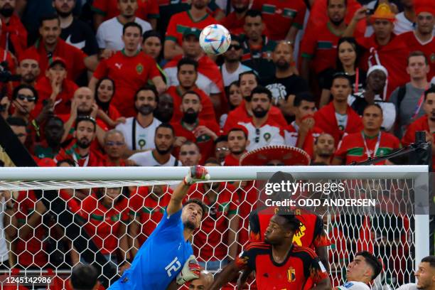 Morocco's goalkeeper Munir Mohand Mohamedi jumps to save the goal during the Qatar 2022 World Cup Group F football match between Belgium and Morocco...