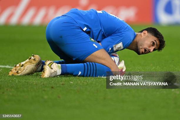 Morocco's goalkeeper Monir El Kajoui saves a shot during the Qatar 2022 World Cup Group F football match between Belgium and Morocco at the...