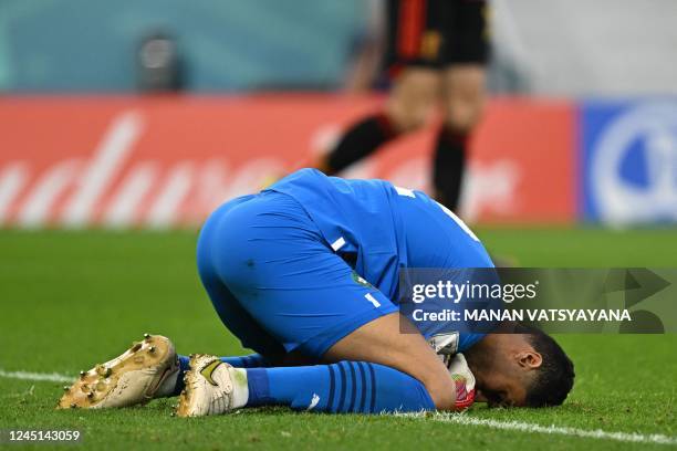 Morocco's goalkeeper Monir El Kajoui saves a shot during the Qatar 2022 World Cup Group F football match between Belgium and Morocco at the...